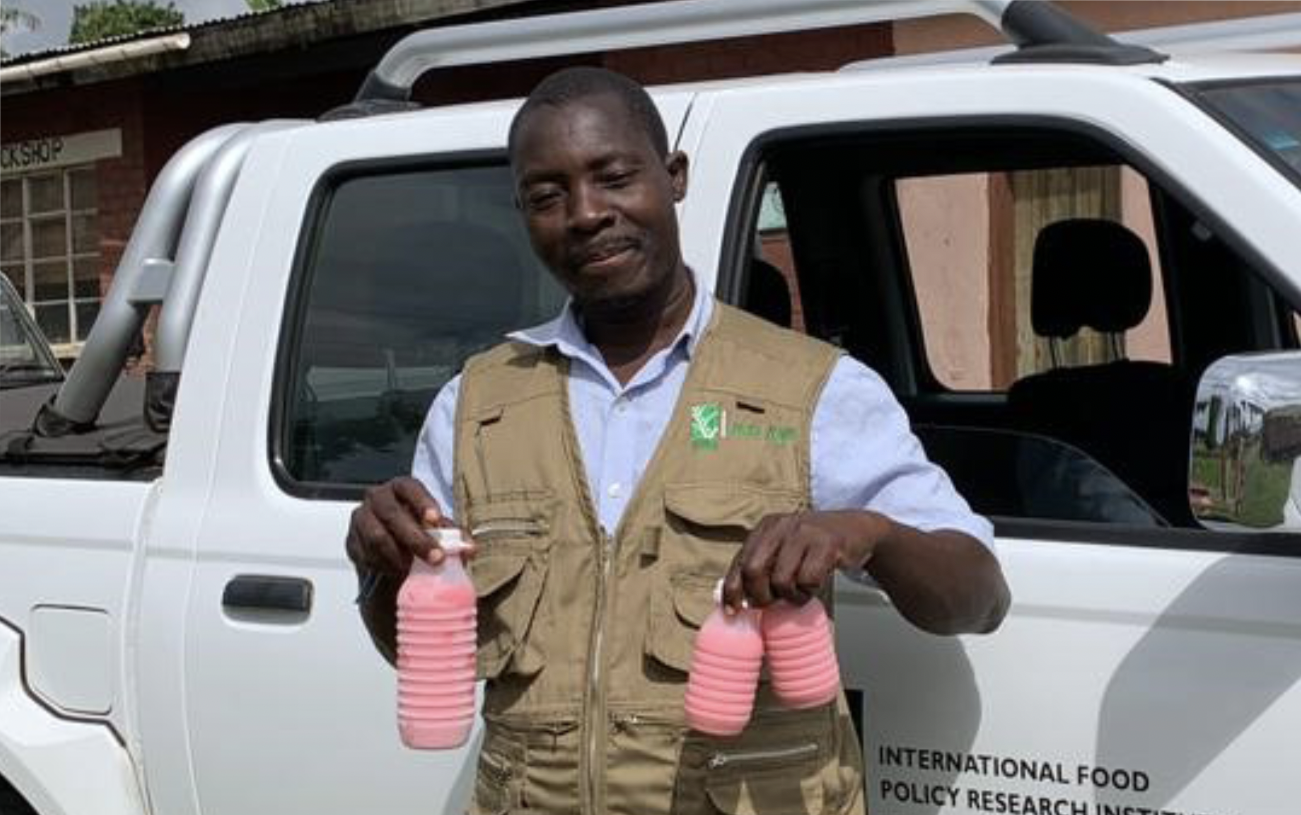 Man carrying three yogurt bottles